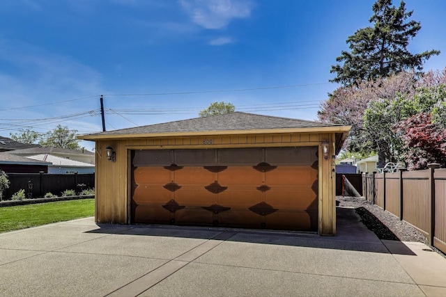 detached garage featuring fence