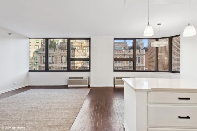 221 E Walton Pl Unit 10B, Chicago, IL 60611 - unfurnished dining area featuring dark wood-style flooring, a wall unit AC, and baseboards