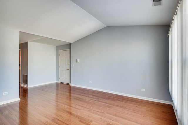 1125 N Red Oak Cir Unit 3, Round Lake Beach, IL 60073 - unfurnished room with light wood-type flooring, baseboards, and vaulted ceiling