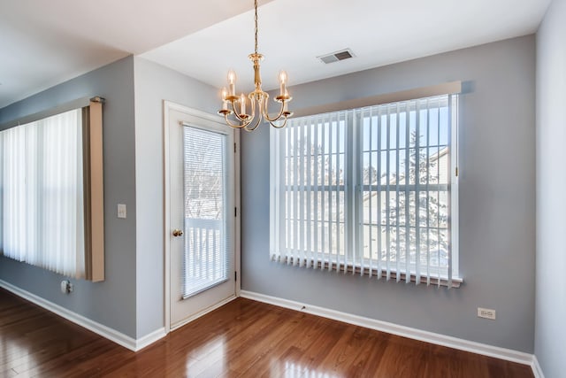 1125 N Red Oak Cir Unit 3, Round Lake Beach, IL 60073 - unfurnished dining area featuring a chandelier, wood finished floors, and baseboards