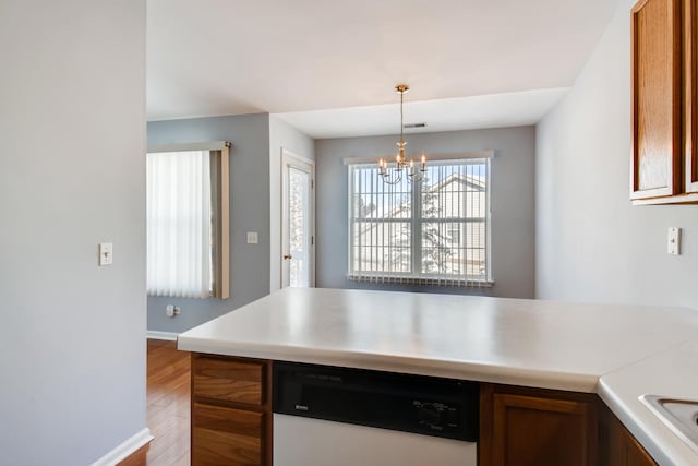 1125 N Red Oak Cir Unit 3, Round Lake Beach, IL 60073 - kitchen with dishwasher, light wood-type flooring, a chandelier, light countertops, and baseboards