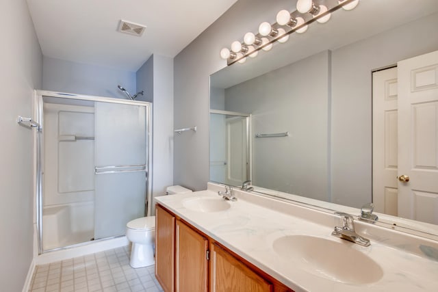 1125 N Red Oak Cir Unit 3, Round Lake Beach, IL 60073 - full bath featuring a stall shower, toilet, double vanity, and baseboards