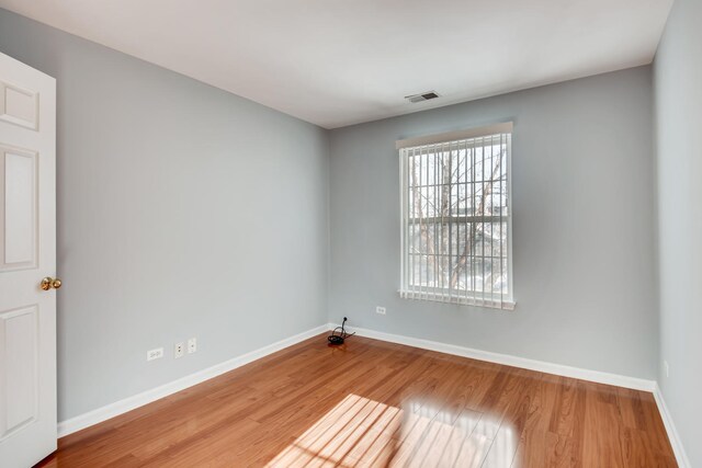 1125 N Red Oak Cir Unit 3, Round Lake Beach, IL 60073 - empty room featuring baseboards and wood finished floors