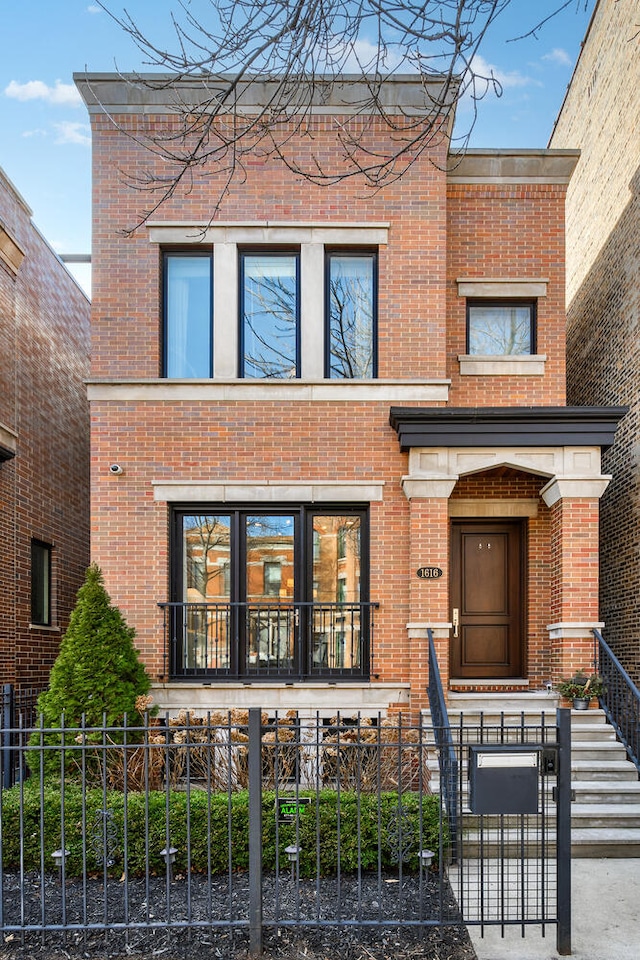 1616 N Winchester Ave, Chicago, IL 60622 - view of front of house with brick siding and a fenced front yard