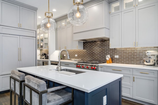 1616 N Winchester Ave, Chicago, IL 60622 - kitchen featuring a sink, light countertops, a kitchen breakfast bar, range, and backsplash