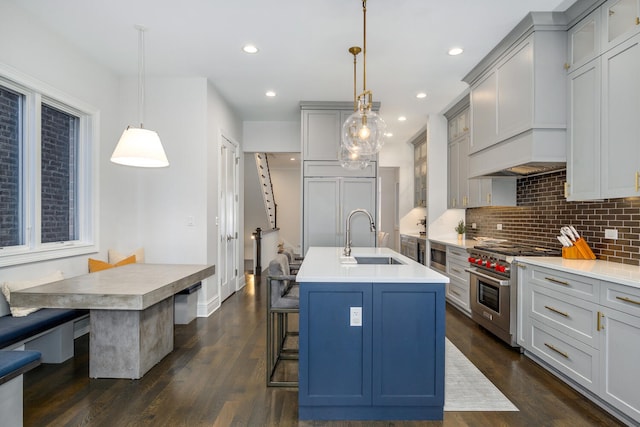 1616 N Winchester Ave, Chicago, IL 60622 - kitchen with built in appliances, a sink, a kitchen island with sink, backsplash, and a kitchen breakfast bar