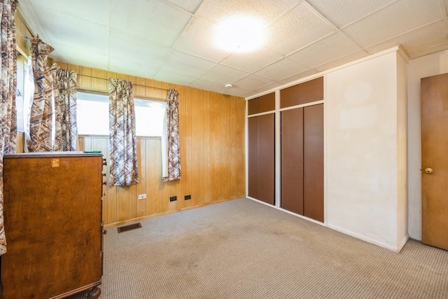 6131 S Brainard Ave, Countryside, IL 60525 - unfurnished bedroom featuring carpet flooring, baseboards, wood walls, and a closet