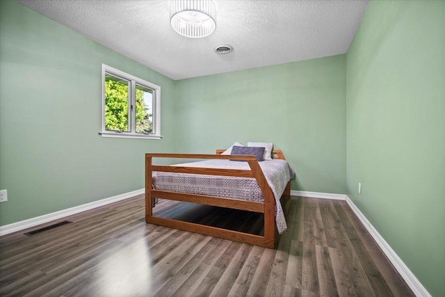 475 E Clay St, El Paso, IL 61738 - bedroom featuring a textured ceiling, wood finished floors, and baseboards