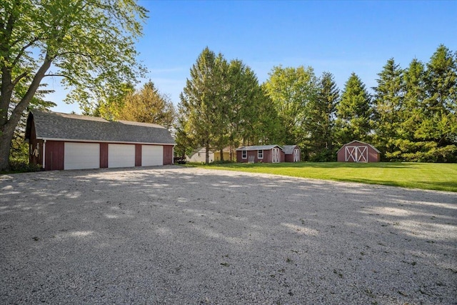 475 E Clay St, El Paso, IL 61738 - view of front of house featuring an outbuilding, a detached garage, and a front yard