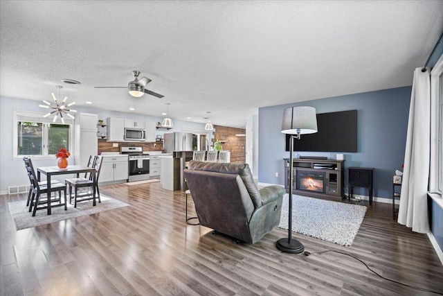 475 E Clay St, El Paso, IL 61738 - living room with a glass covered fireplace, light wood-style floors, ceiling fan, baseboards, and recessed lighting