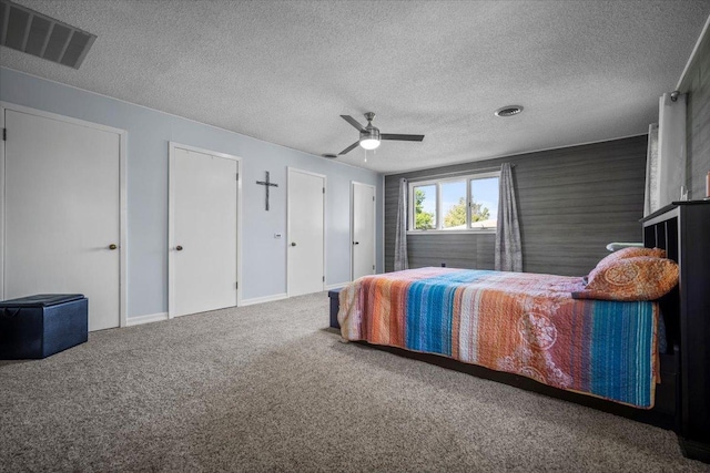475 E Clay St, El Paso, IL 61738 - bedroom with carpet floors, a textured ceiling, a ceiling fan, and multiple closets
