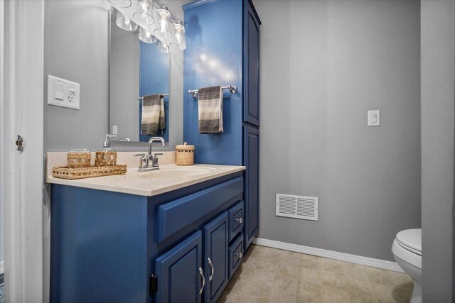 475 E Clay St, El Paso, IL 61738 - bathroom with baseboards, toilet, and vanity
