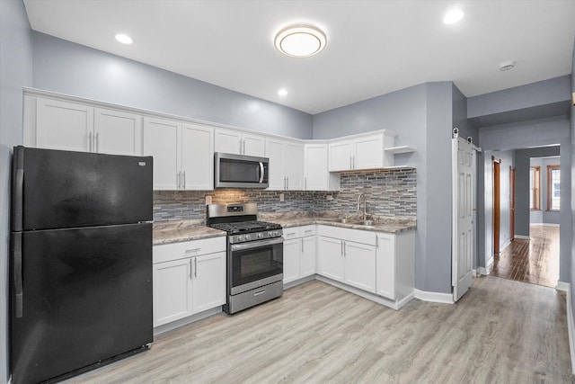 1238 S Harding Ave, Chicago, IL 60623 - kitchen featuring appliances with stainless steel finishes, a sink, open shelves, white cabinets, and decorative backsplash