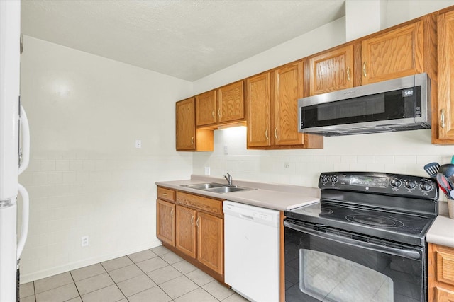 608 Hessel Blvd, Champaign, IL 61820 - kitchen featuring stainless steel microwave, dishwasher, black electric range oven, a sink, and brown cabinetry