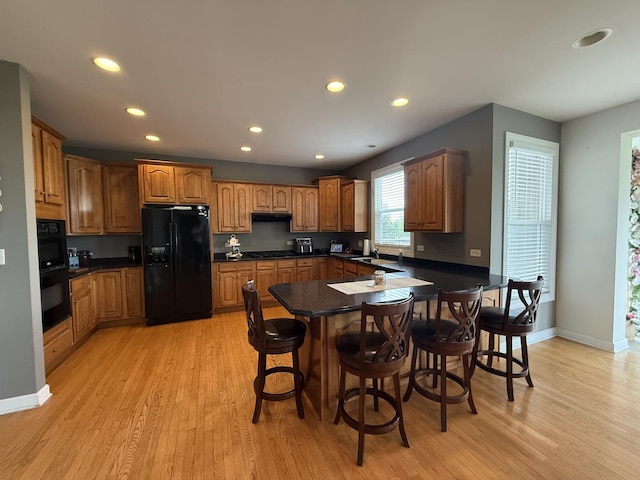 43W465 Otter Ln, Saint Charles, IL 60175 - kitchen with black appliances, a peninsula, light wood-style floors, recessed lighting, and a sink