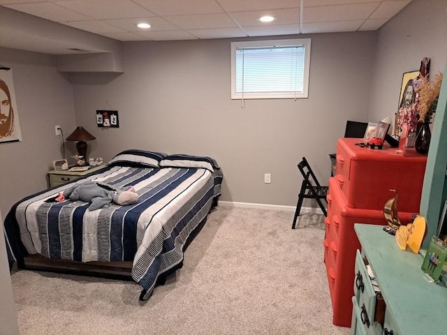 carpeted bedroom with a drop ceiling, baseboards, and recessed lighting