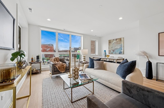 living room featuring light wood finished floors and recessed lighting