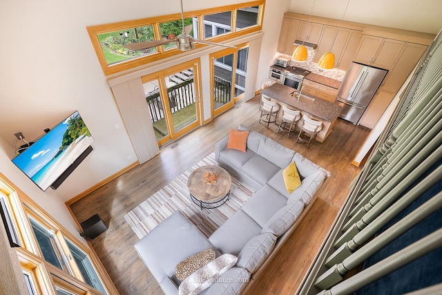 14530 136th St, Lemont, IL 60439 - living area with a towering ceiling, light wood finished floors, and baseboards