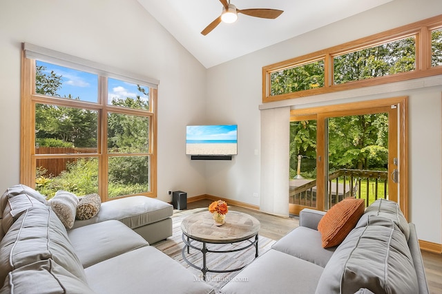14530 136th St, Lemont, IL 60439 - living room with baseboards, ceiling fan, light wood-style floors, and high vaulted ceiling