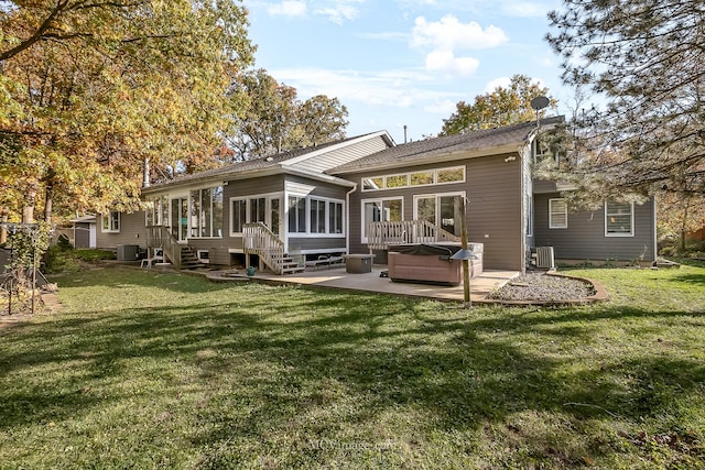14530 136th St, Lemont, IL 60439 - back of house featuring a sunroom, a patio area, a lawn, and central AC