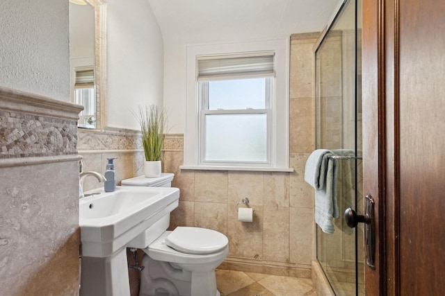 225 N Knight Ave, Park Ridge, IL 60068 - bathroom featuring a stall shower, toilet, tile walls, a sink, and tile patterned floors