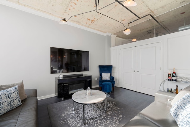 living area with wood finished floors and baseboards