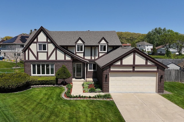 tudor house with brick siding, roof with shingles, driveway, stucco siding, and a garage