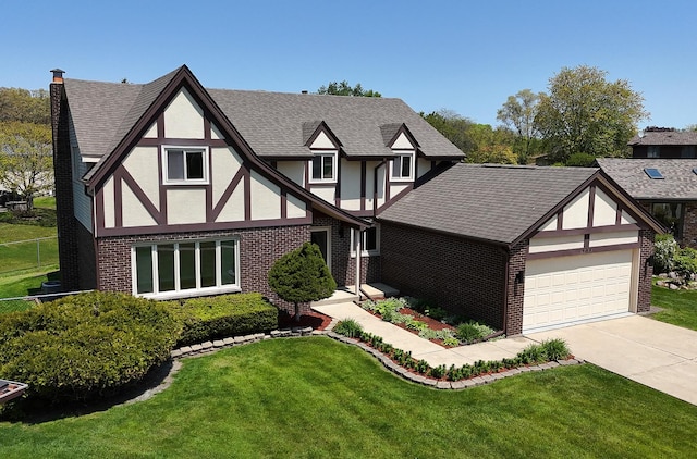 tudor house with stucco siding, brick siding, a garage, and a shingled roof