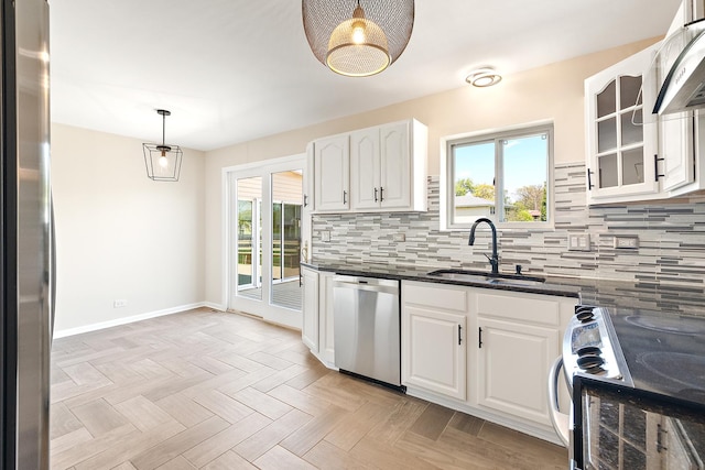 kitchen with appliances with stainless steel finishes, a sink, under cabinet range hood, and healthy amount of natural light