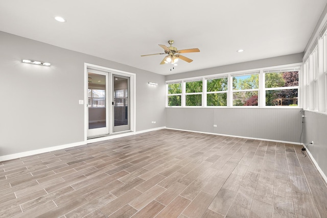 spare room with ceiling fan, baseboards, light wood-style floors, and recessed lighting
