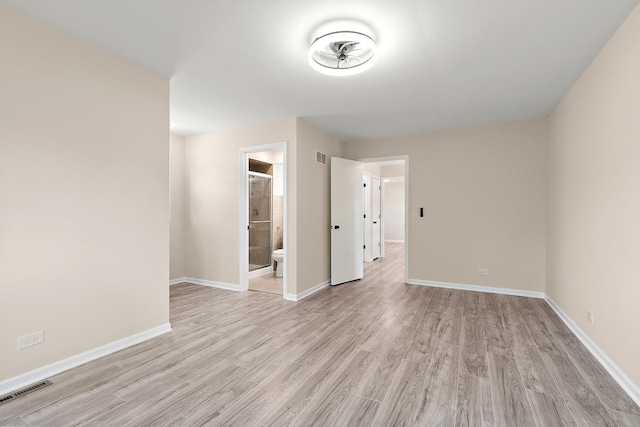 unfurnished room with light wood-style floors and baseboards