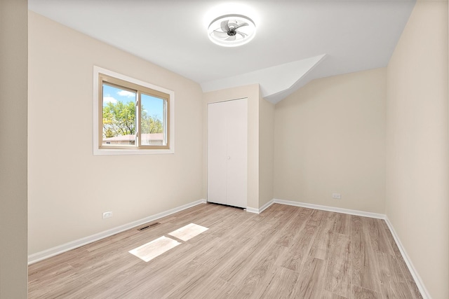 unfurnished bedroom featuring light wood finished floors and baseboards