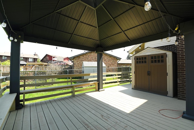 deck featuring a storage unit, an outdoor structure, and a gazebo