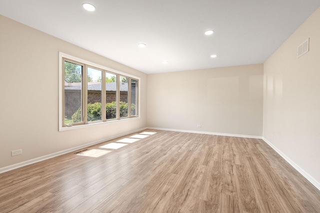 spare room with light wood-style floors, recessed lighting, and baseboards
