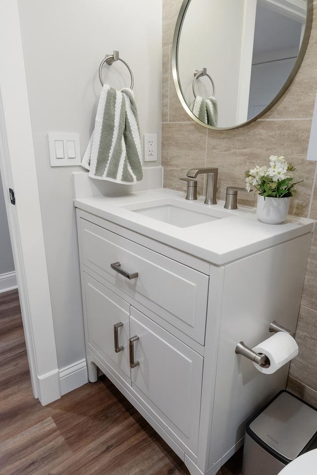 4937 N Opal Ave, Norridge, IL 60706 - bathroom featuring tasteful backsplash, vanity, wood finished floors, and baseboards