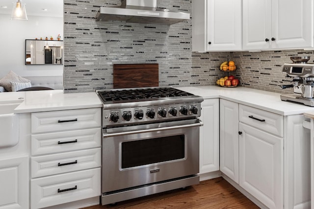4937 N Opal Ave, Norridge, IL 60706 - kitchen with stainless steel range, wall chimney range hood, tasteful backsplash, and white cabinetry