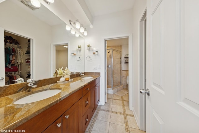 1907 W Chicago Ave Unit 3, Chicago, IL 60622 - bathroom featuring tile patterned floors, a stall shower, double vanity, and a spacious closet