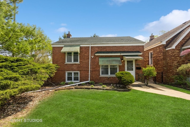 4035 Grove Ave, Stickney, IL 60402 - view of front of house featuring a front lawn, brick siding, a chimney, and roof with shingles