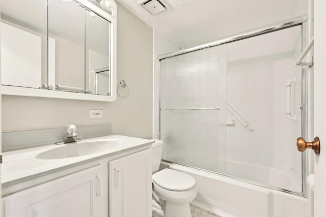 bathroom with toilet, enclosed tub / shower combo, vanity, and tile patterned floors