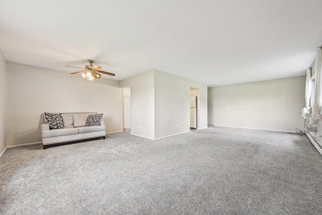 unfurnished living room with carpet, baseboards, and ceiling fan