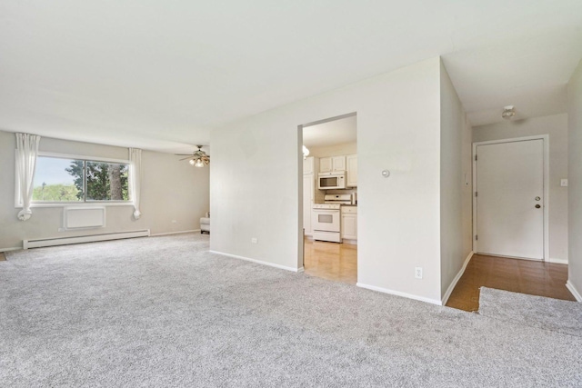unfurnished living room with baseboard heating, light colored carpet, a ceiling fan, and baseboards