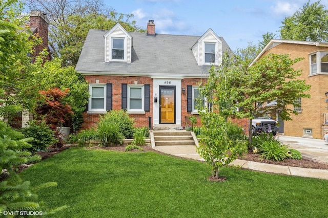 496 Longcommon Rd, Riverside, IL 60546 - cape cod home with brick siding, a front lawn, and a chimney