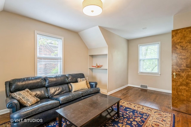 496 Longcommon Rd, Riverside, IL 60546 - living area featuring plenty of natural light, wood finished floors, built in features, vaulted ceiling, and baseboards