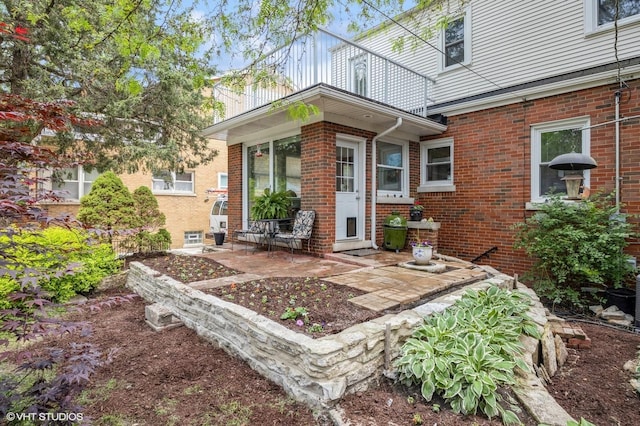 496 Longcommon Rd, Riverside, IL 60546 - doorway to property with brick siding and a patio