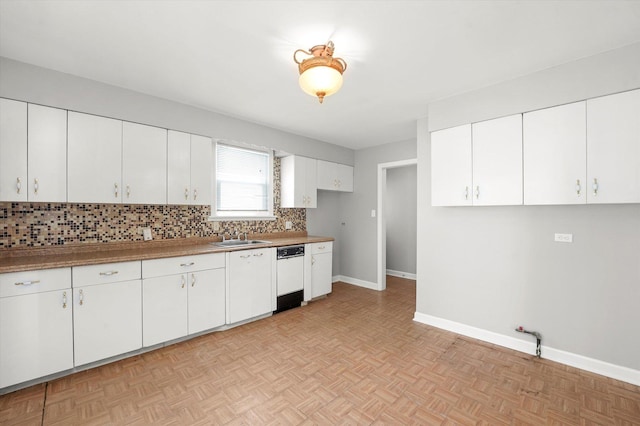 255 Irving Blvd, Chicago Heights, IL 60411 - kitchen with dishwasher, tasteful backsplash, baseboards, a sink, and white cabinets