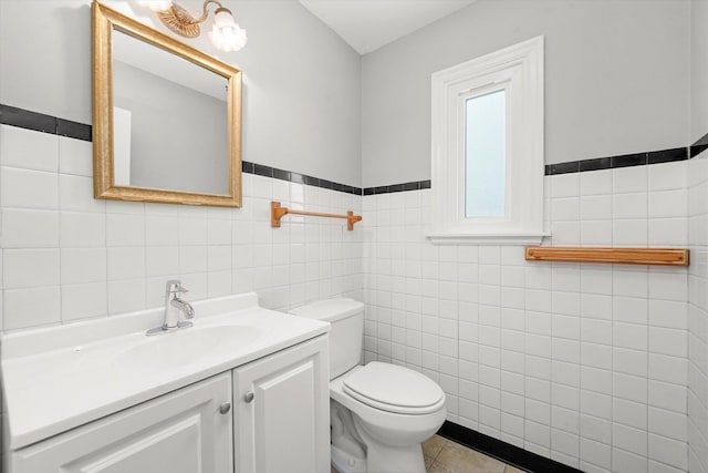 255 Irving Blvd, Chicago Heights, IL 60411 - bathroom featuring tile walls, toilet, vanity, wainscoting, and tile patterned flooring