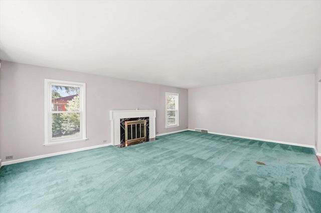 255 Irving Blvd, Chicago Heights, IL 60411 - unfurnished living room featuring baseboards, a premium fireplace, and carpet flooring