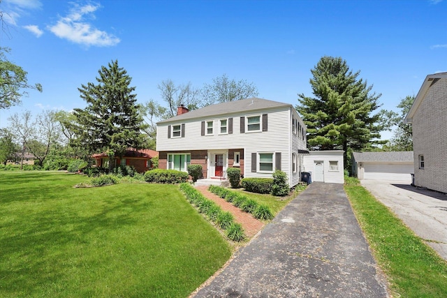 255 Irving Blvd, Chicago Heights, IL 60411 - view of front of house featuring a chimney, a front lawn, an outdoor structure, and a garage