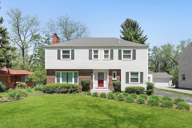 255 Irving Blvd, Chicago Heights, IL 60411 - view of front of property featuring a chimney, a front lawn, an outdoor structure, brick siding, and a garage