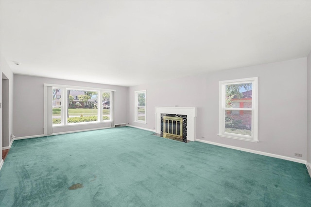 255 Irving Blvd, Chicago Heights, IL 60411 - unfurnished living room featuring baseboards, healthy amount of natural light, a premium fireplace, and carpet flooring